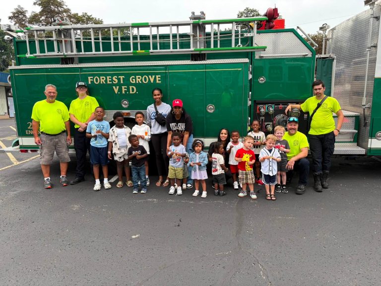 Forest Grove Volunteer Fire Department members teaching fire safety to children at a local preschool